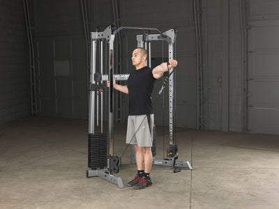 Body-Solid GDCC210 functional trainer dual weight stacks bar silver and black shoulder exercises