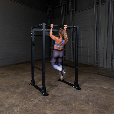 Woman doing pull-ups on PPR400 body solid power rack