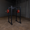 Body solid power rack with barbell and red bumper plates