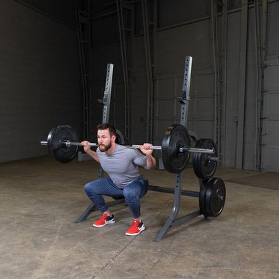 man doing back squat on powerline squat rack
