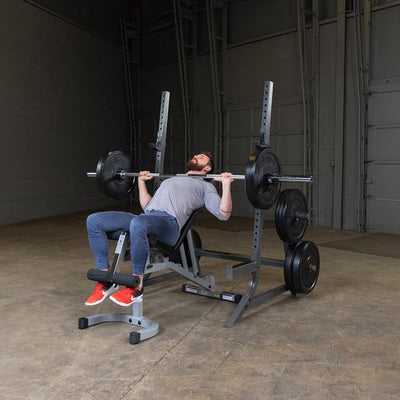 man doing incline bench press on powerline squat rack