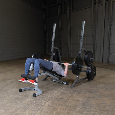 man doing decline bench press on powerline pmp150 with bumper plates