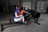 Endurance R300 rower black side view with women exercising