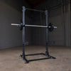 Body Solid SPR500 half rack black with pull-up bar, j-hooks, safety spotter barbell bumper plates