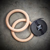 Wood gymnastic rings black straps tan wood color with numbered straps and heavy duty buckles