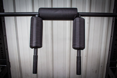 safety squat bar with pad over shoulder arms simpsons fitness supply